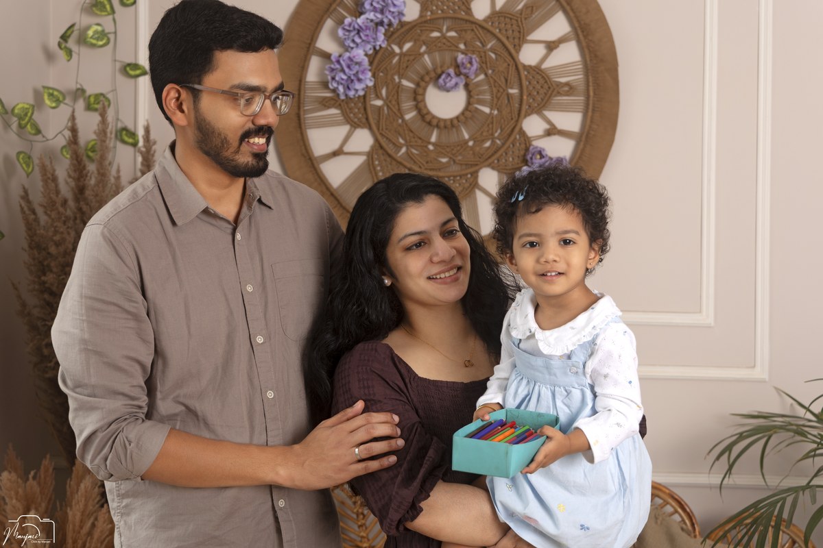 Parents with their daughter in a warm studio setting